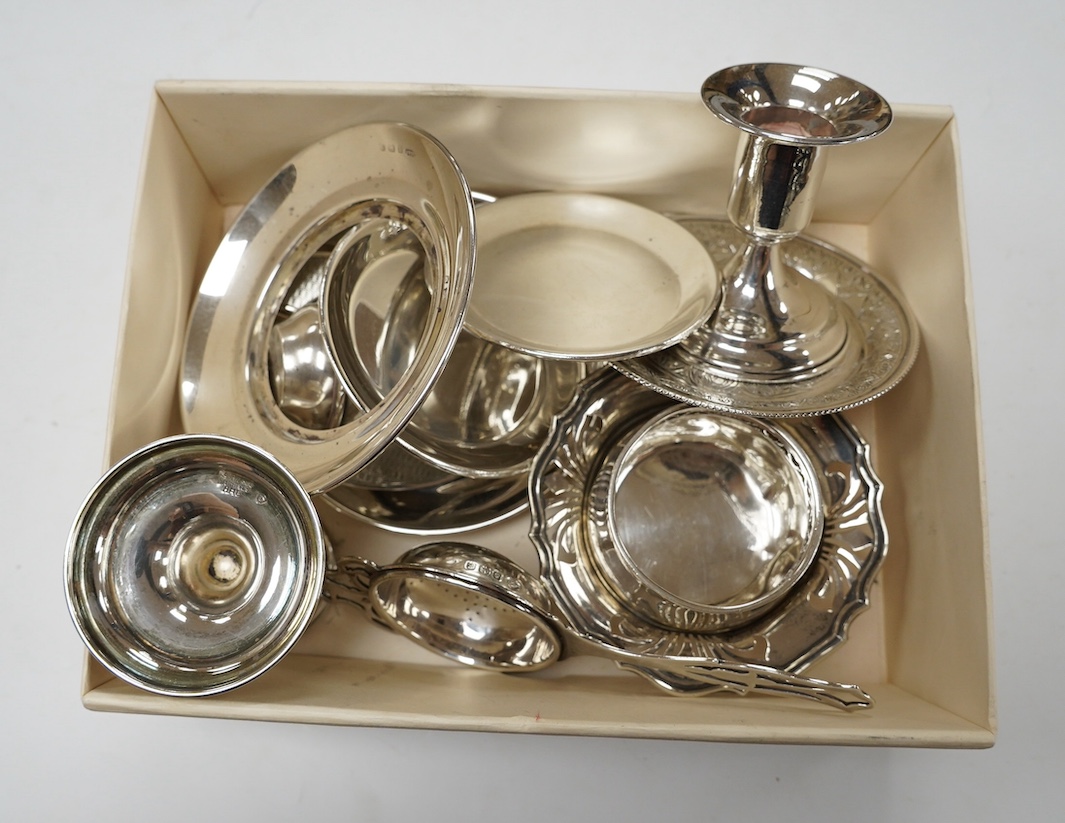 Sundry small silver and white metal items including silver tea strainer on stand and ashtray, pierced silver bowl, sterling dishes and dwarf candlesticks, etc. Condition - poor to fair